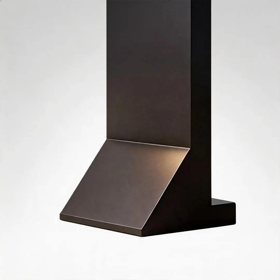 Modern solar bollard light with angled black metal base and textured finish