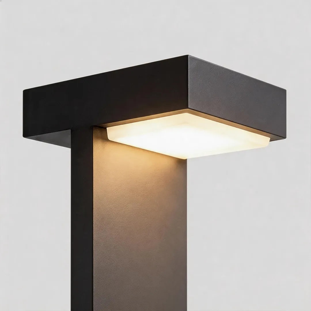 Modern solar bollard light with square LED head and warm downward illumination