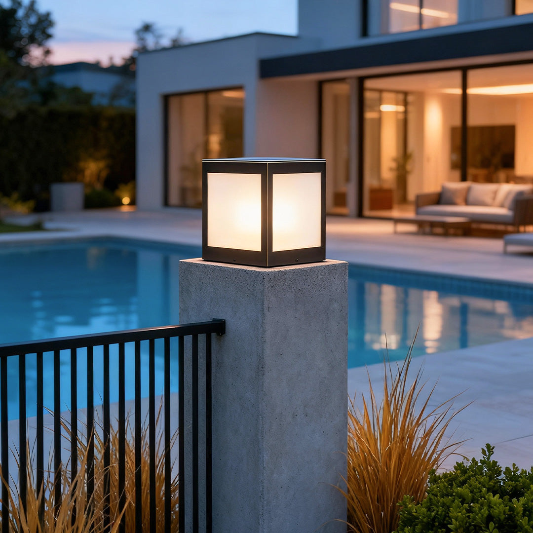 Modern solar outdoor pillar lights enhancing a poolside area with soft, warm illumination.
