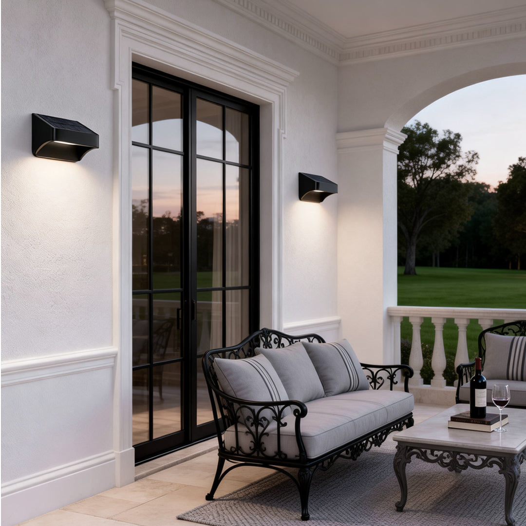 Modern solar outdoor wall lights dusk to dawn mounted beside patio doors, enhancing outdoor seating area ambiance.