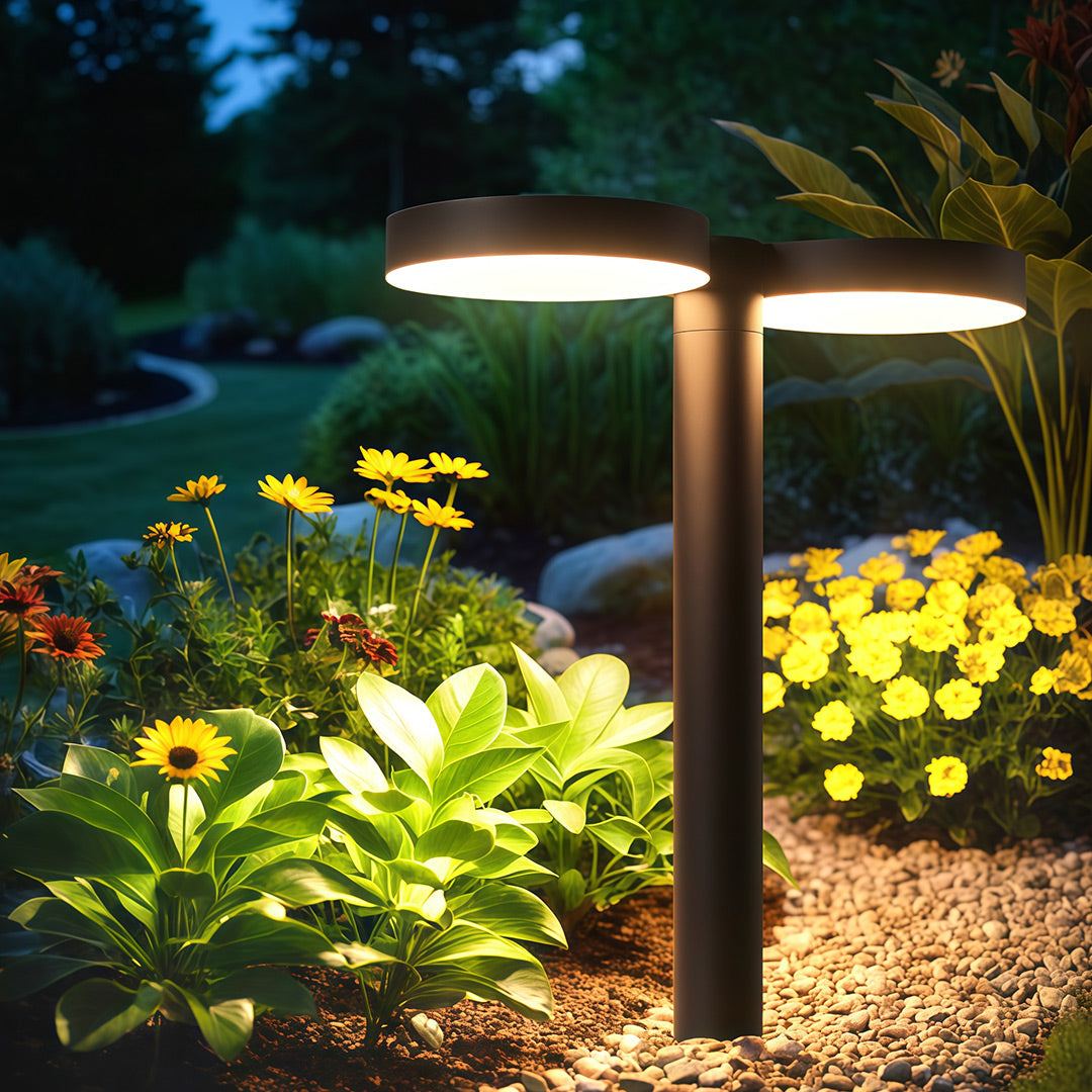 Modern solar path light positioned near a lush garden, adding elegance to the walkway.