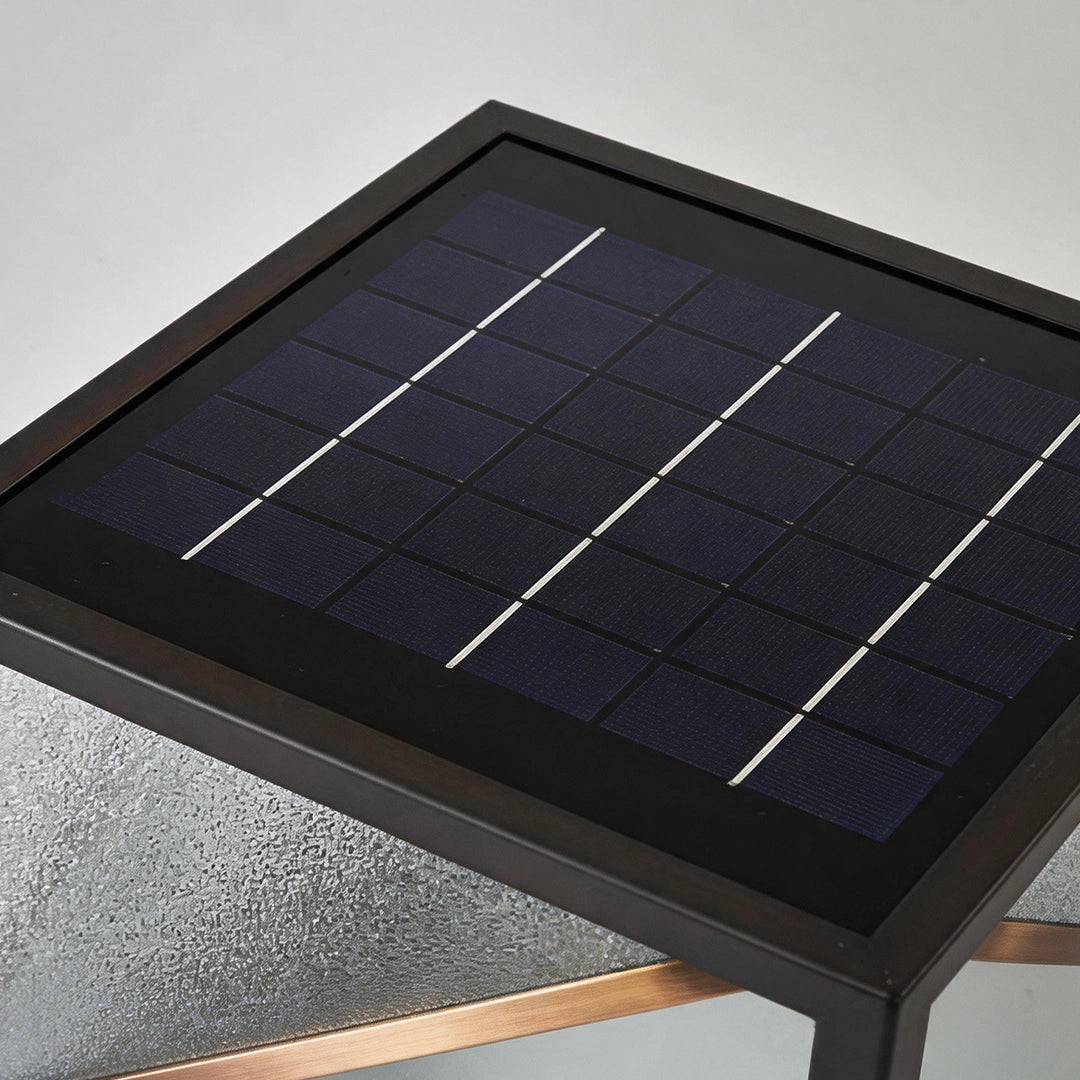 Modern solar pillar light with integrated top solar panel and black metal frame