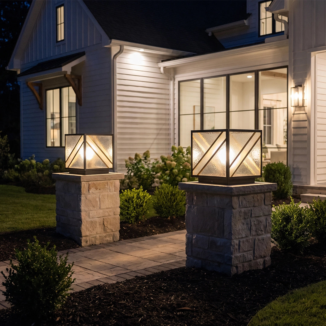 Modern solar pillar lights illuminating stone columns along home walkway