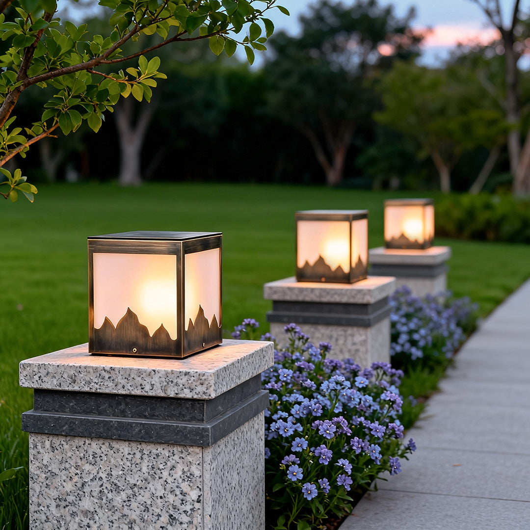 Modern solar powered pillar lights mounted on a brick pillar, enhancing the beauty of a garden pathway.
