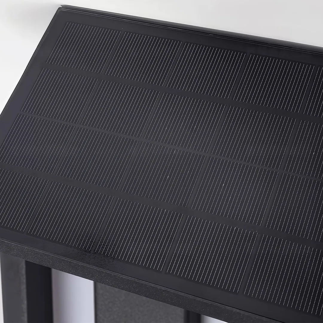 Modern solar wall sconce with integrated black solar panel detail