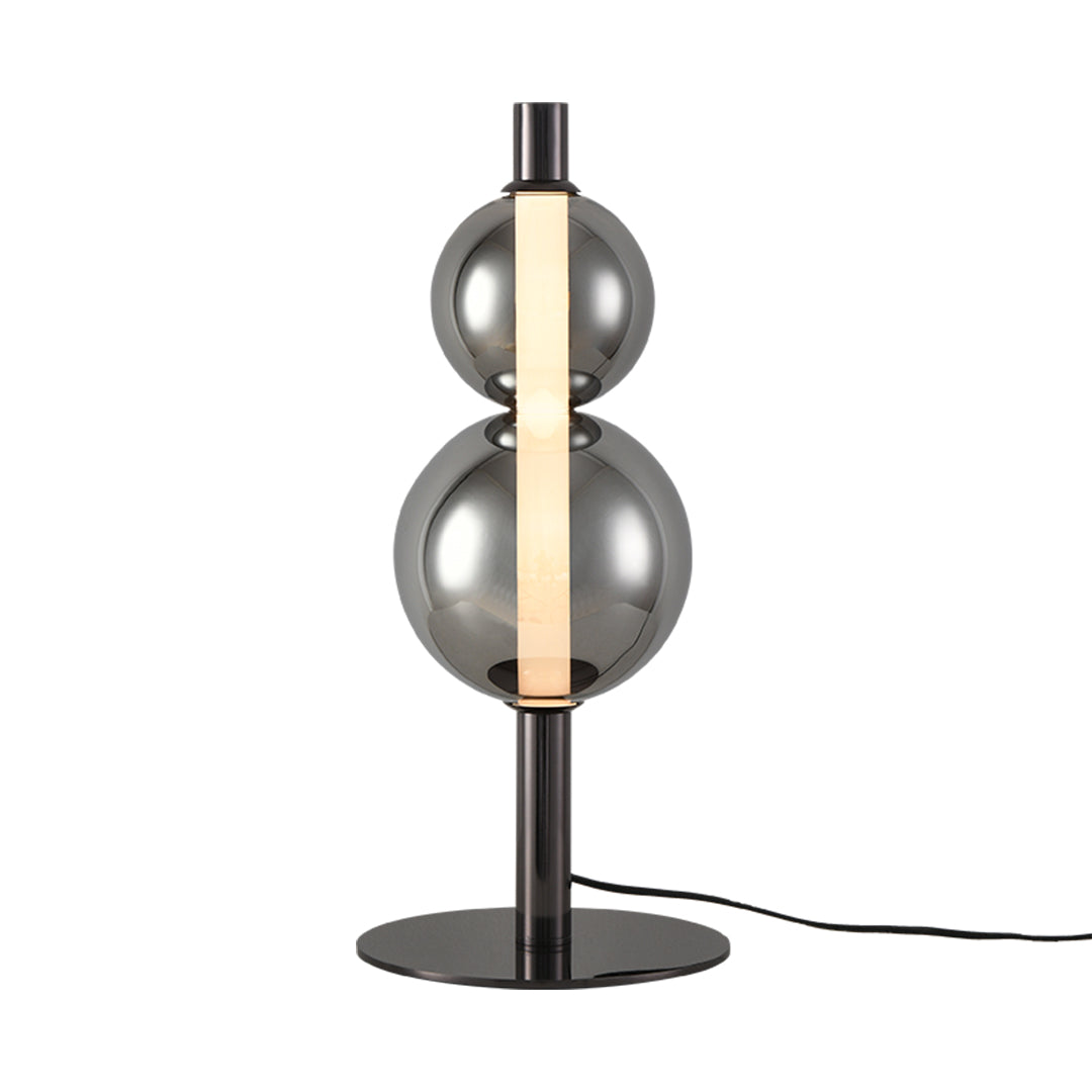 Modern art table lamp with stacked spherical elements creating dramatic shadow effects