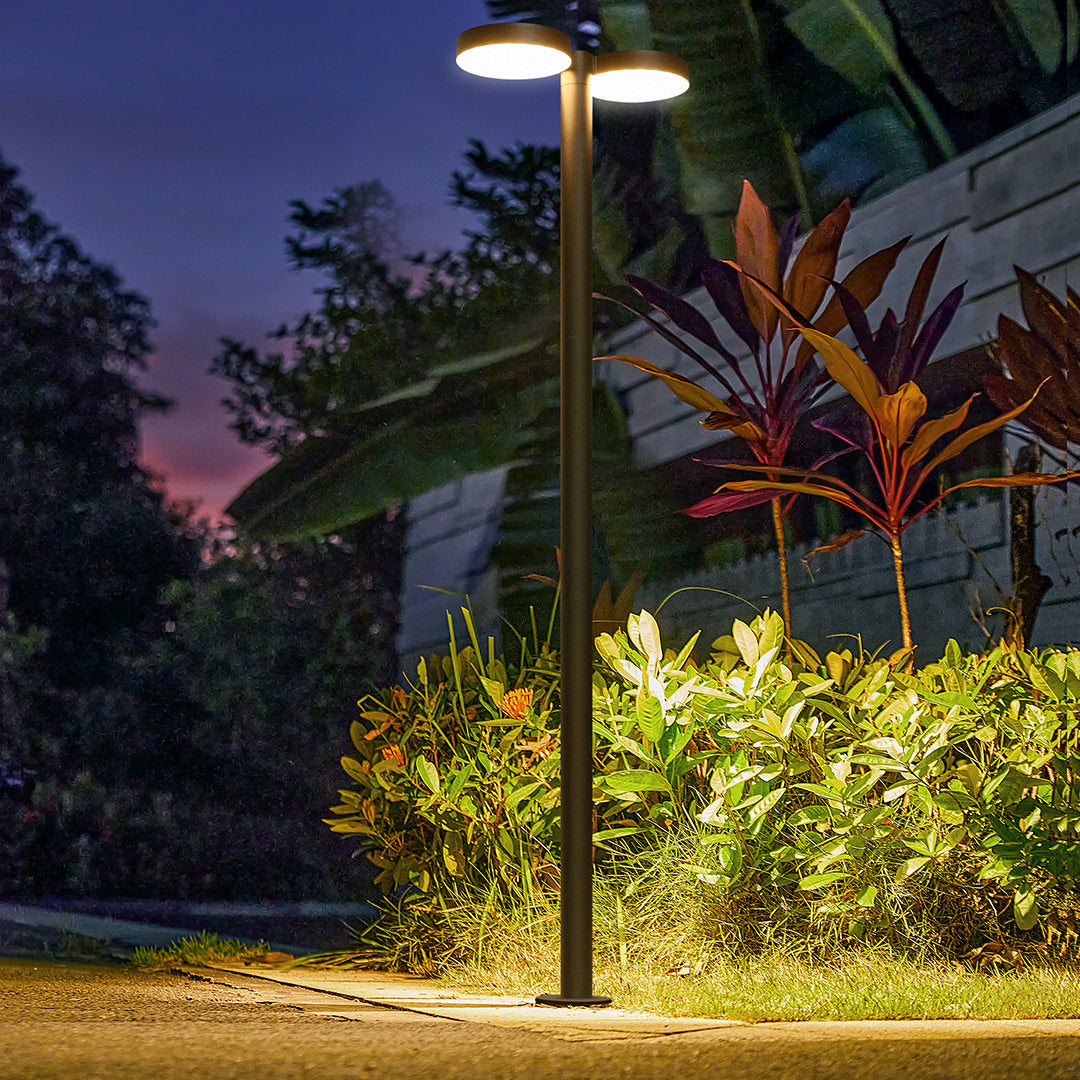 Modern street lights lining a well-maintained outdoor space at dusk, offering a serene glow.