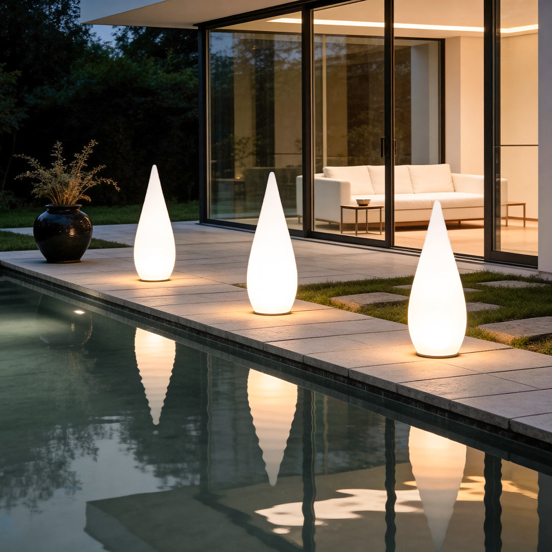 Modern teardrop outdoor lights arranged on lawn for decorative landscape lighting.
