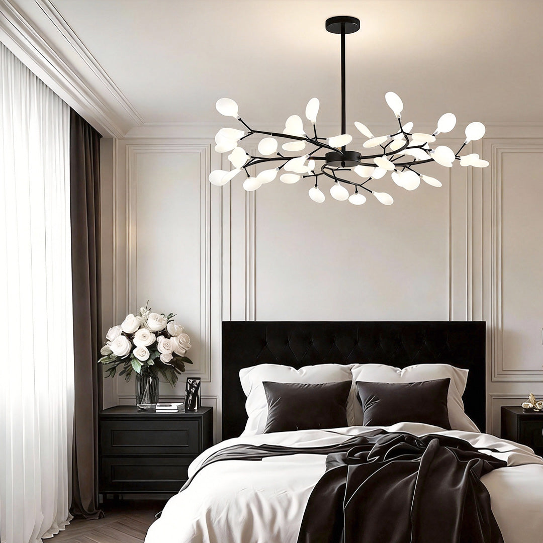 Modern tree branch chandelier illuminating a luxurious bedroom with warm, elegant glow.