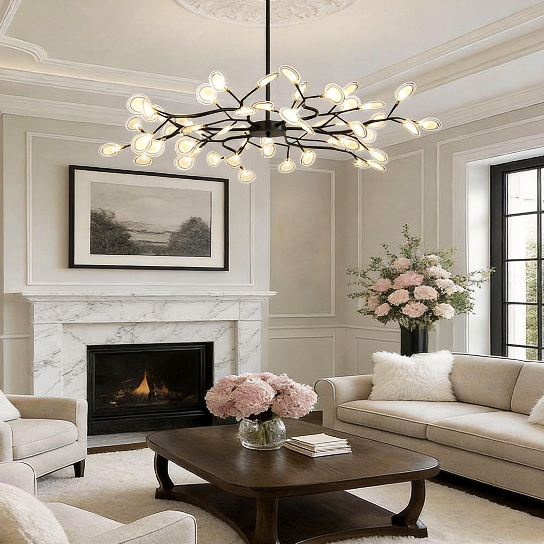 Modern tree branch chandelier providing soft illumination above a classic living room fireplace.