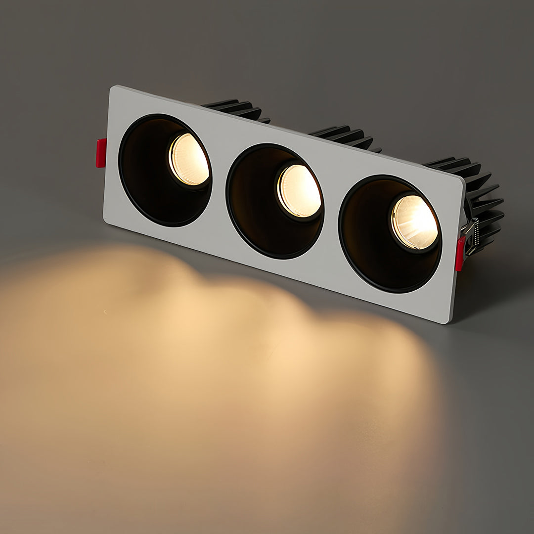 Modern triple square recessed downlight with black interior and white frame for focused lighting