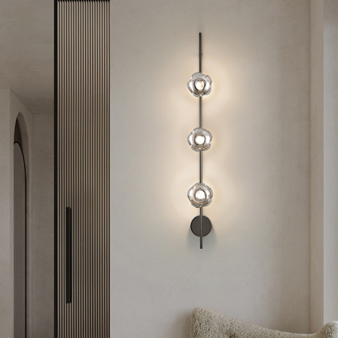 Modern indoor wall mounted lights with vertical glass globe arrangement in minimalist bedroom