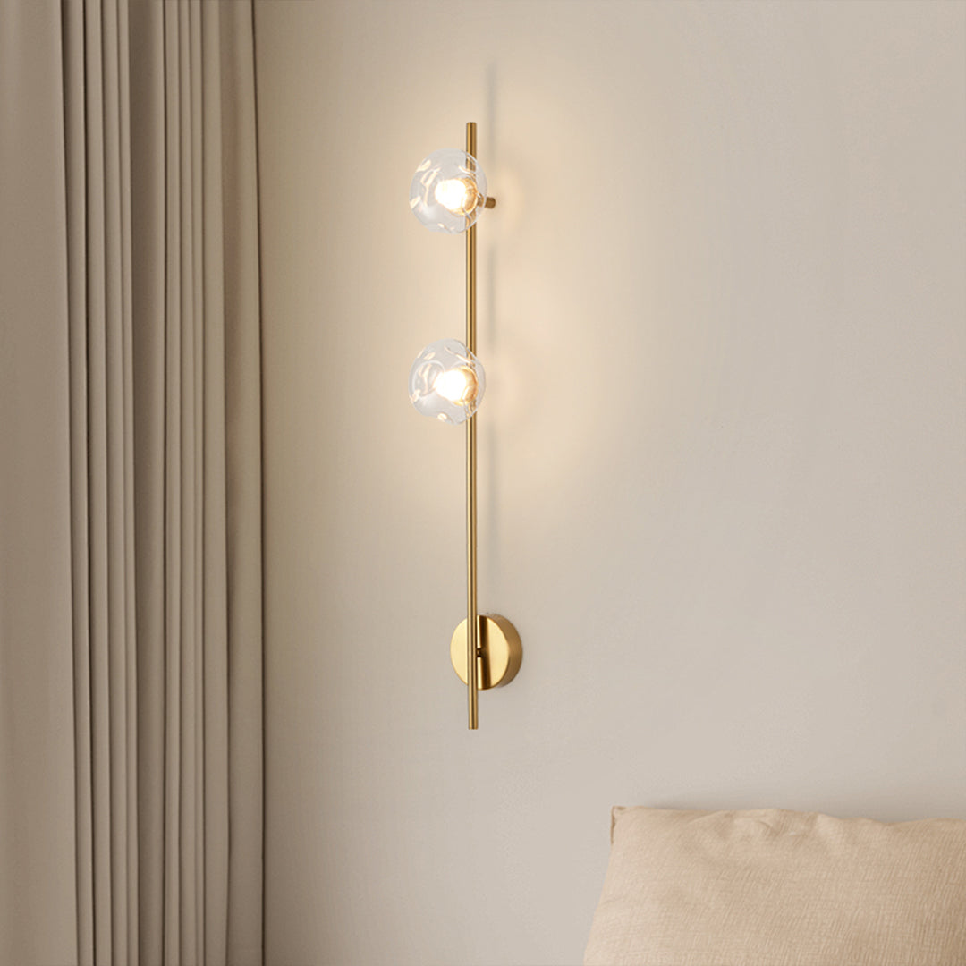 Modern indoor wall mounted lights with vertical glass globe arrangement in minimalist bedroom