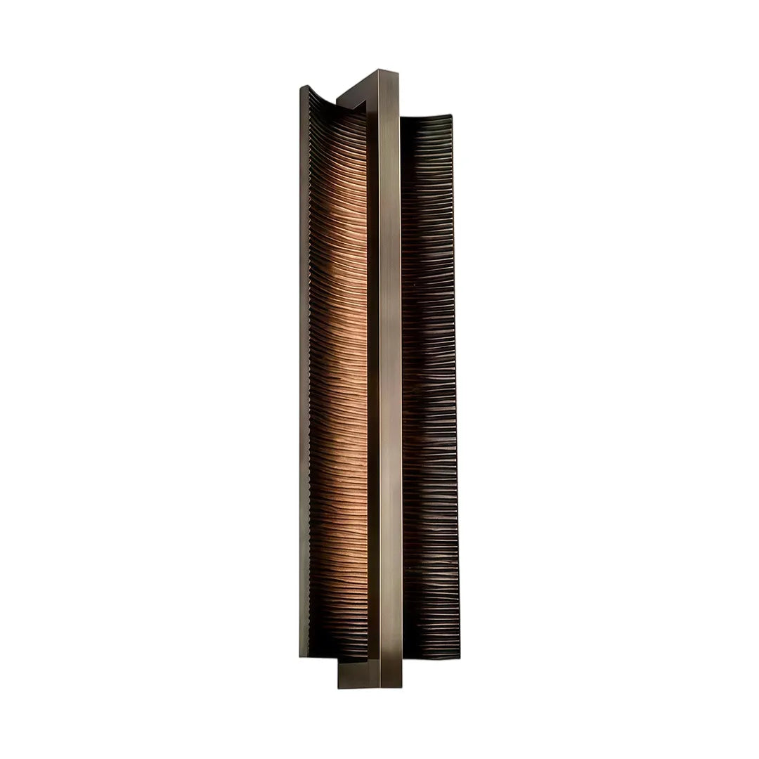 Modern vertical wall sconce with bronze finish textured shade and warm lighting