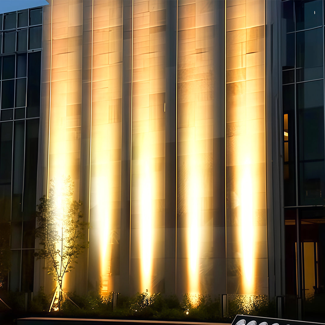 Modern villa exterior highlighted by warm square wall wash lights.
