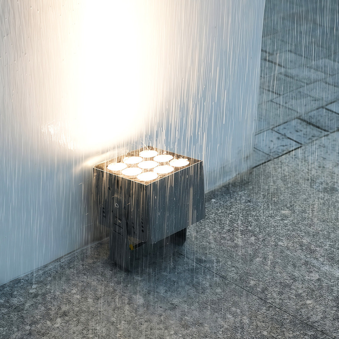 Modern villa exterior highlighted by warm square wall wash lights.