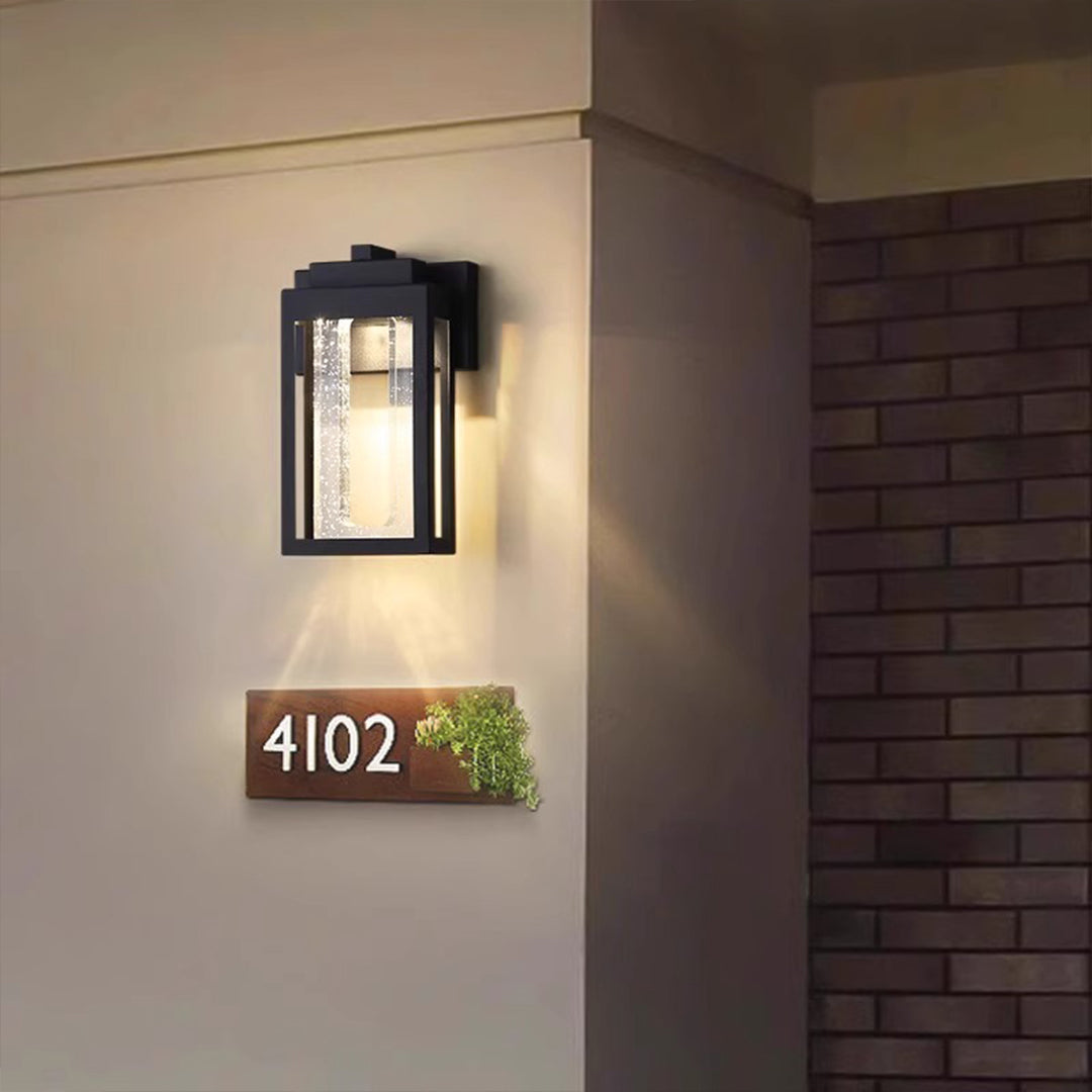 Modern wall lantern illuminating apartment entrance with warm ambient lighting