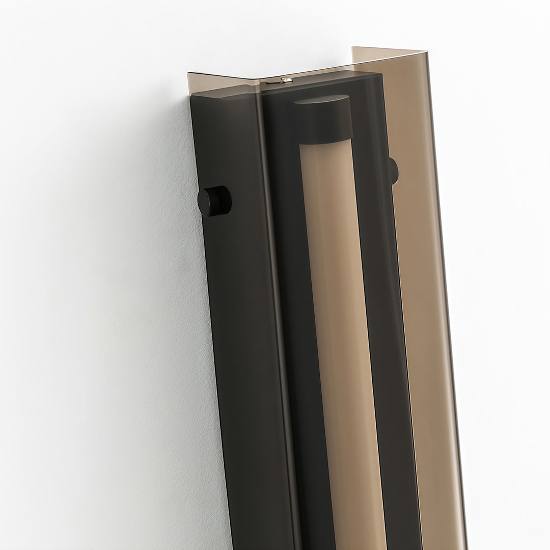 Modern wall light decoration with a black and gold finish, featuring a unique layered design.