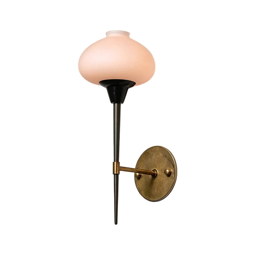 Modern wall light fixture isolated product view with a frosted glass shade and brass wall mount.