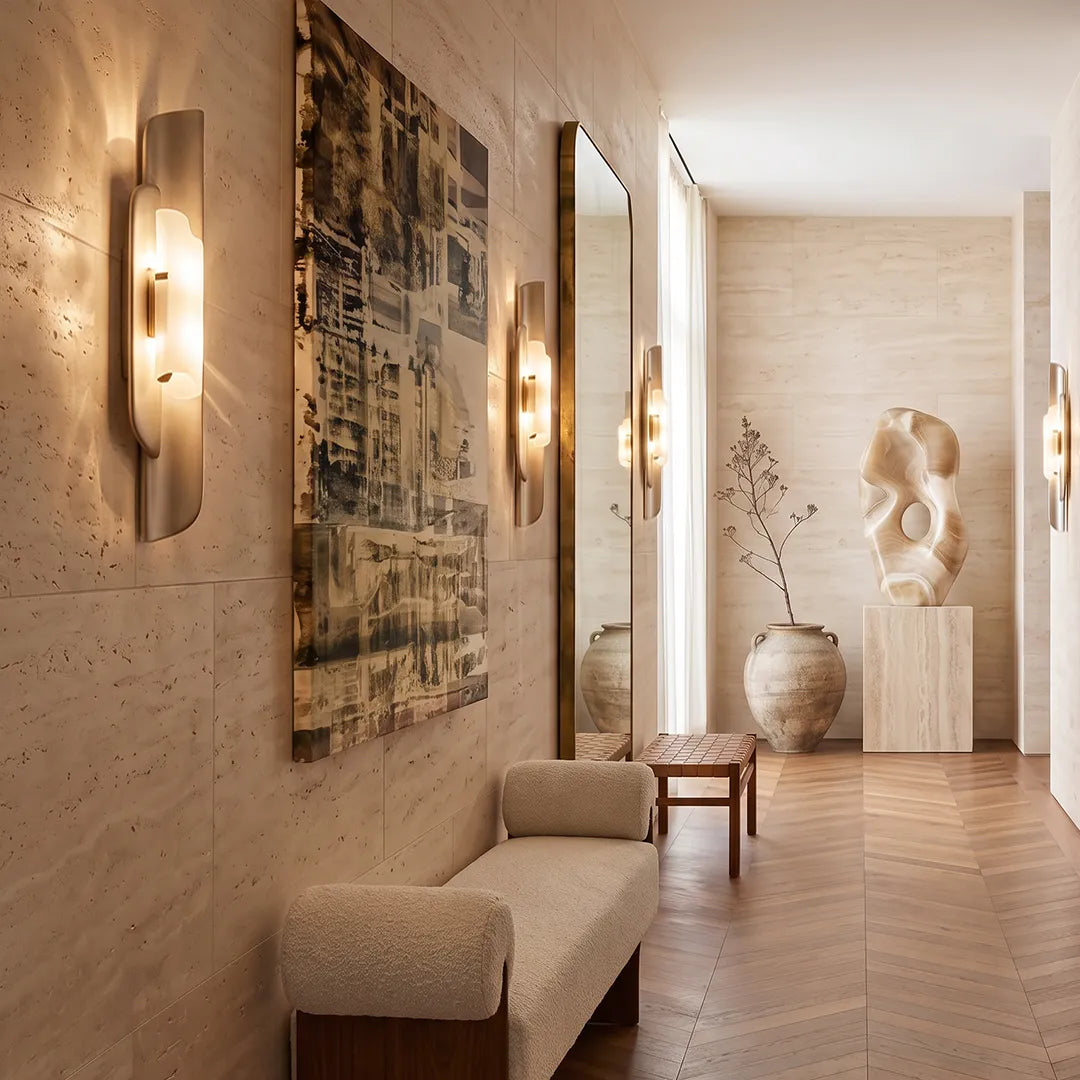 Modern wall light fixtures installed along a hallway with wood walls and sculptural decor.