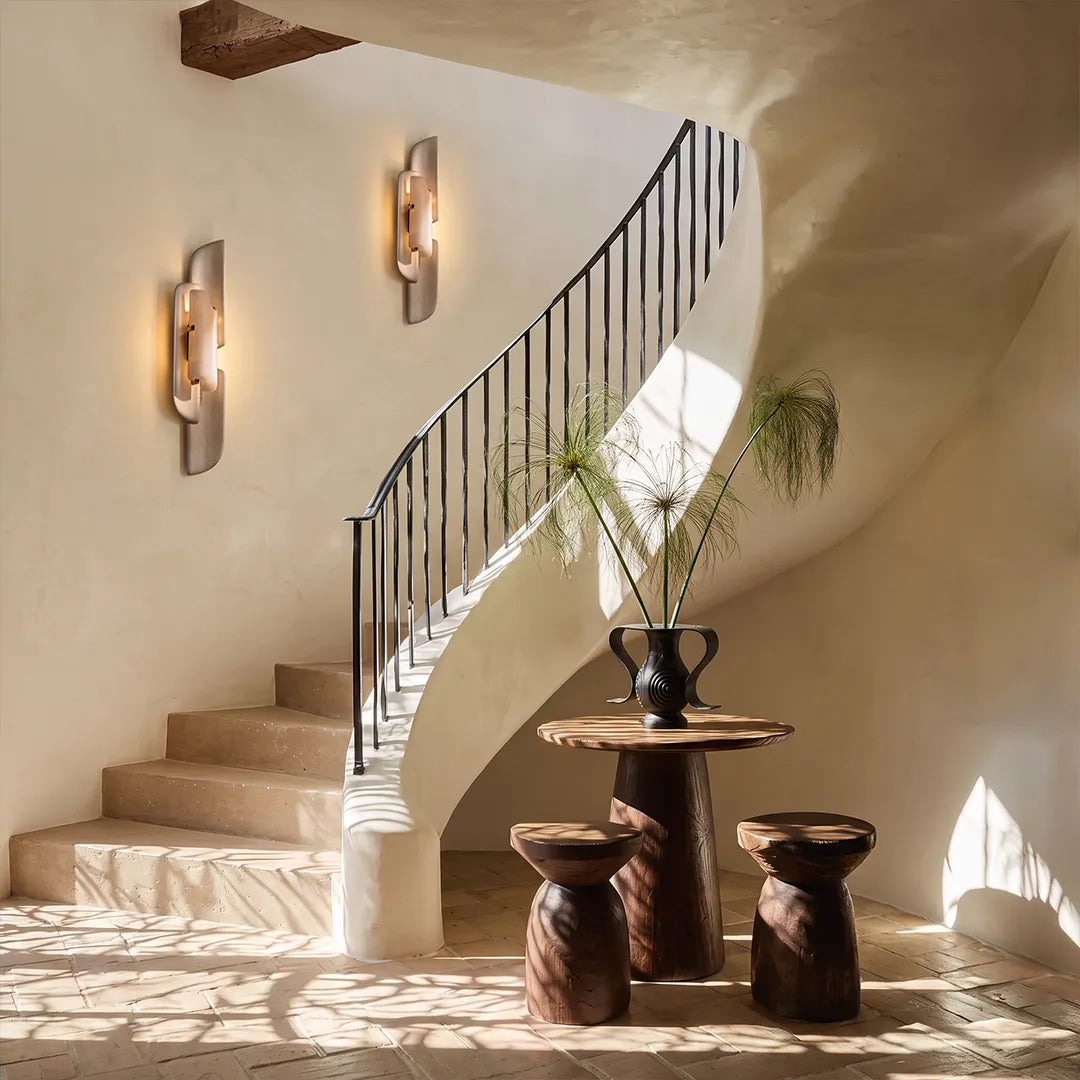 Modern wall light fixtures mounted along a staircase wall in a bright contemporary interior.