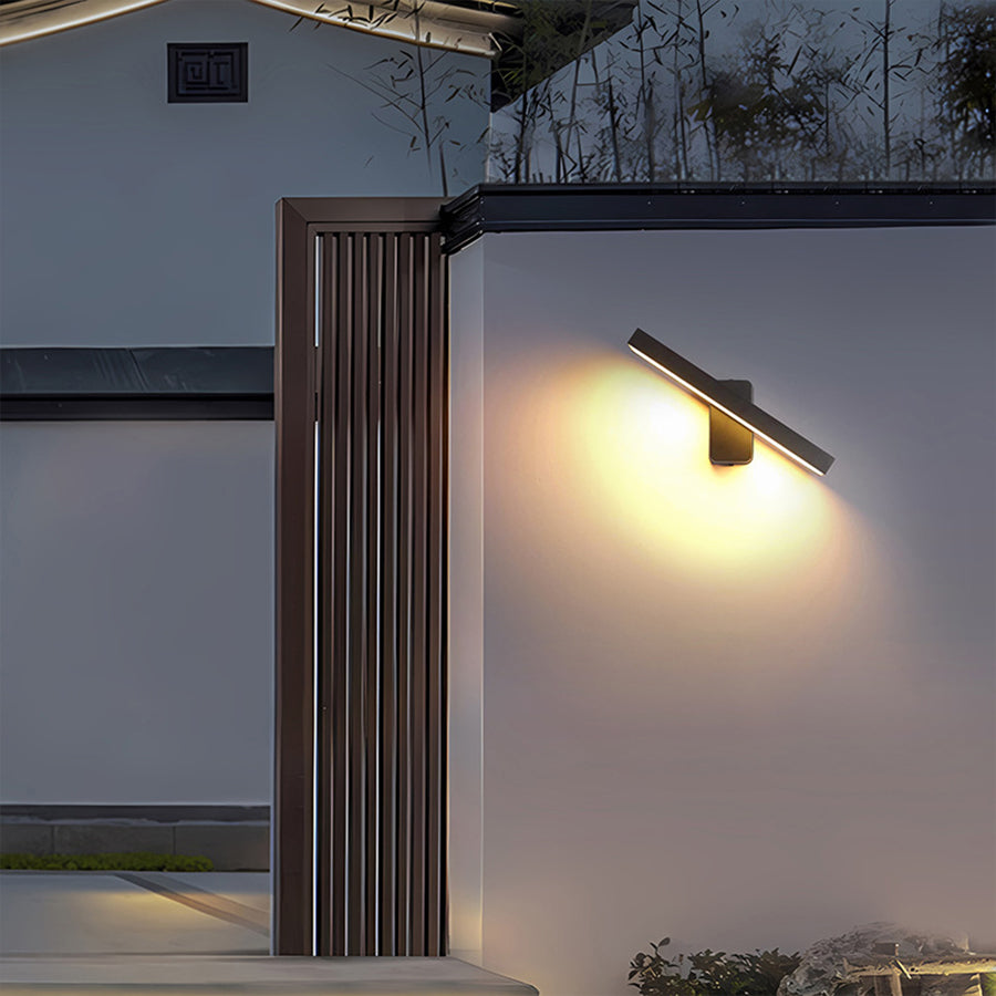 Modern wall light installed on outdoor building column with directional lighting