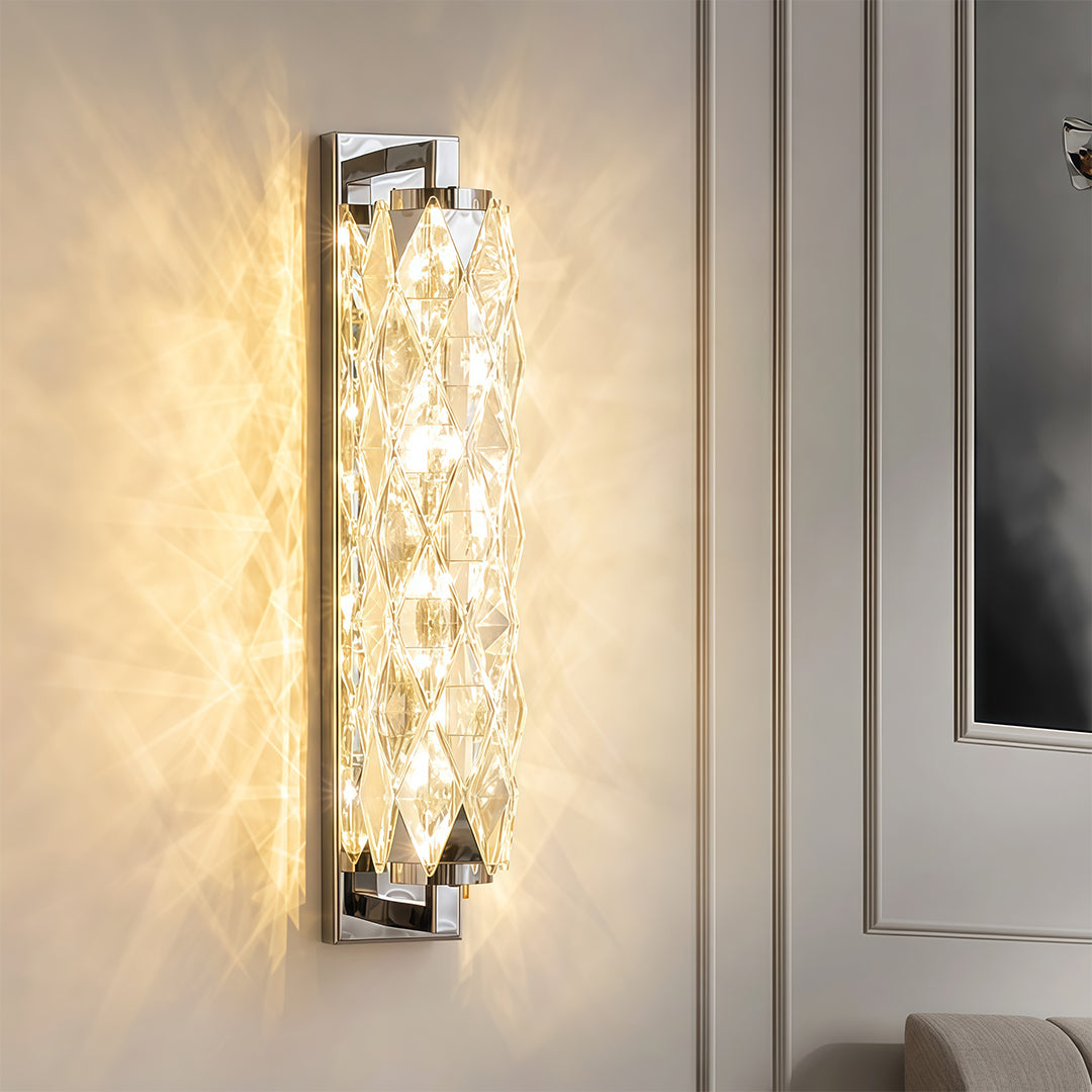 Modern wall light providing soft illumination on neutral wall with decorative bottle and greenery.