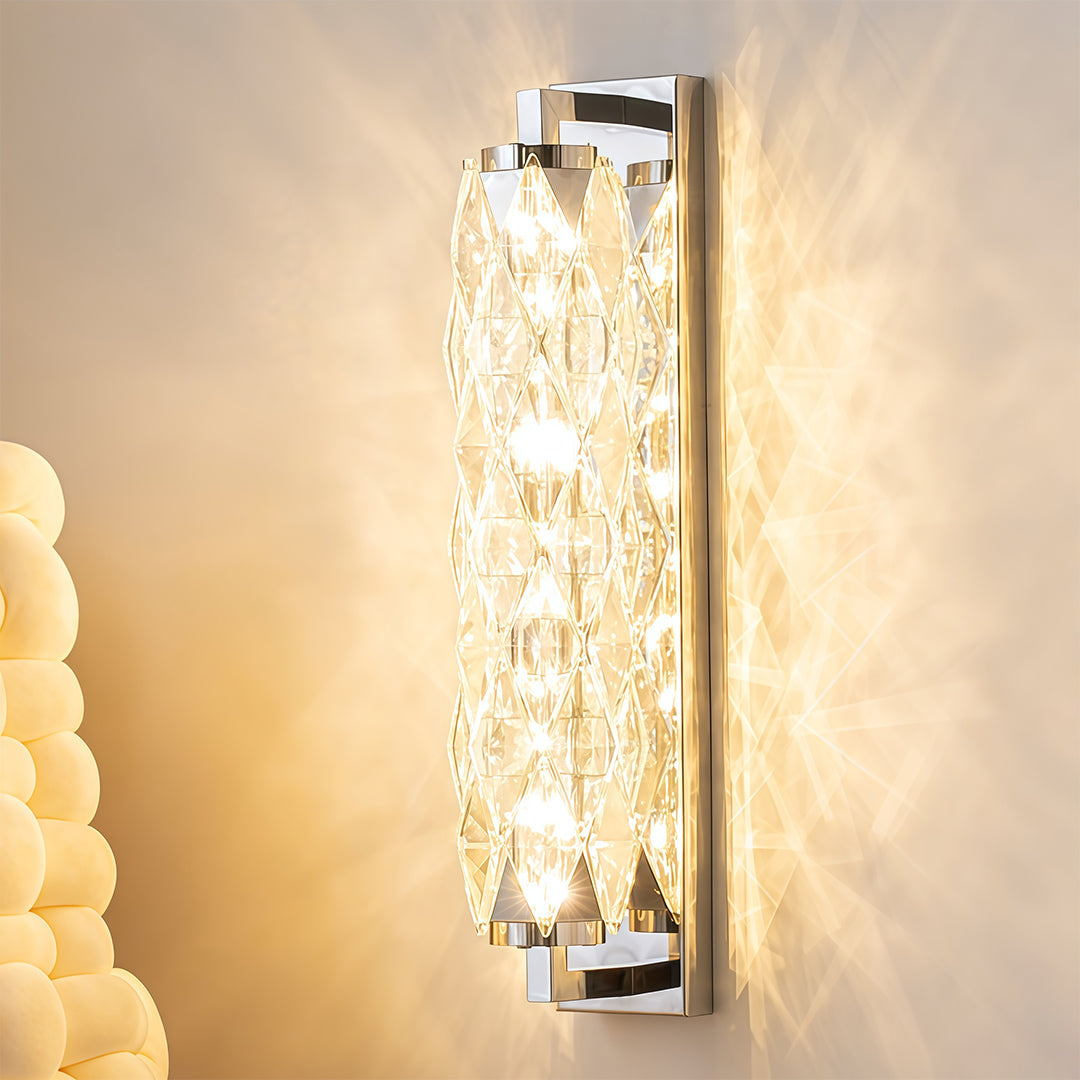 Modern wall light casting warm glow on beige wall near door frame in minimalist hallway.