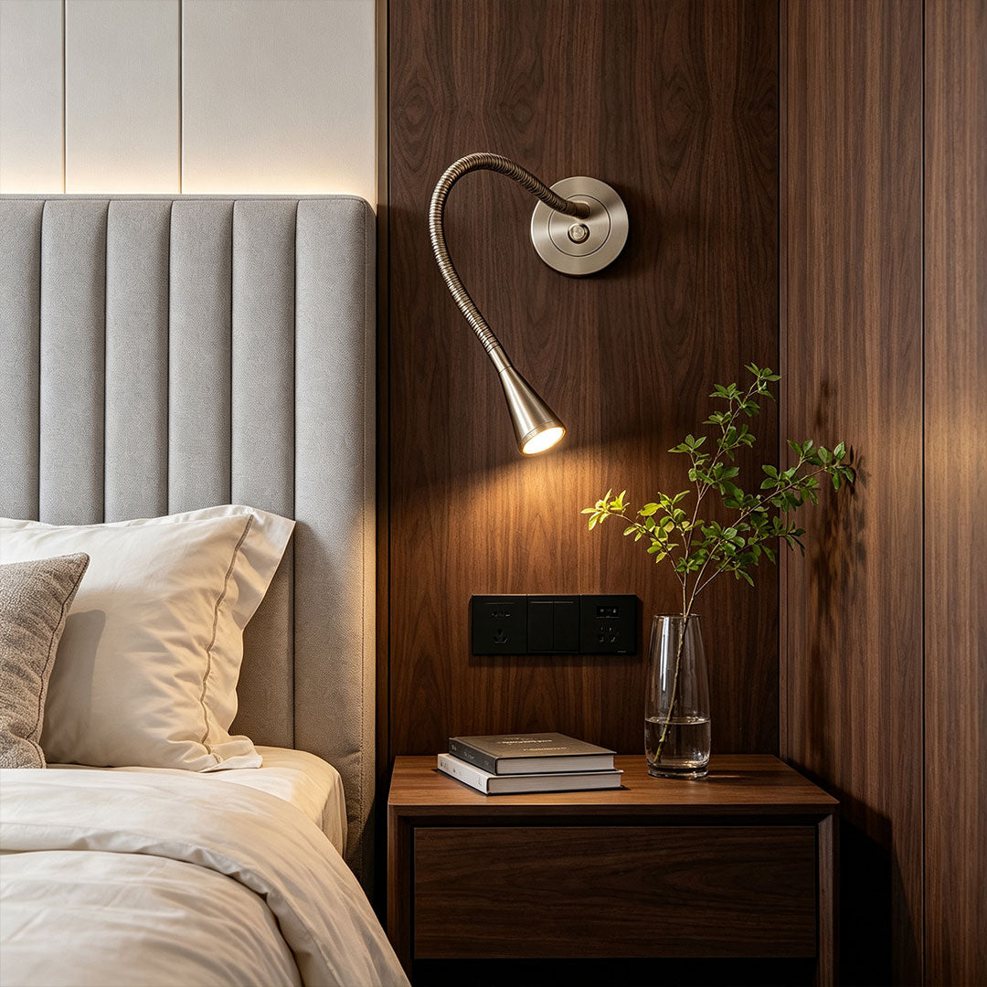 Modern wall light with swing arm installed beside a contemporary bedroom bed.