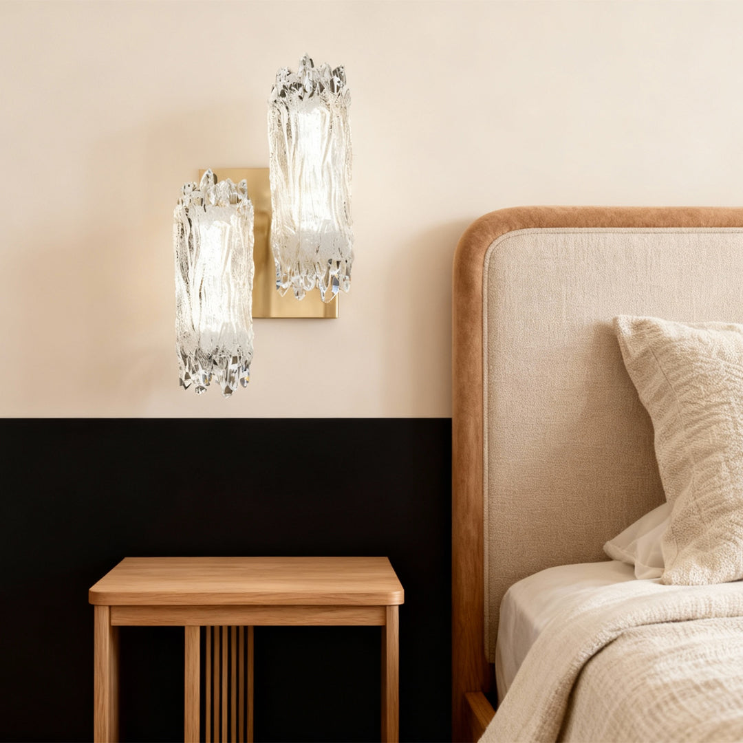 Modern wall lighting mounted above nightstand in minimalist bedroom with natural wood and cream color scheme