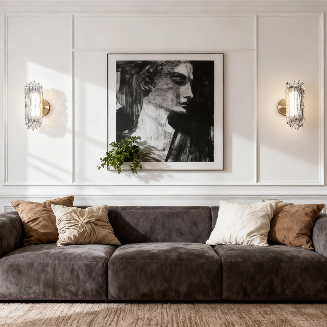 Pair of modern wall lighting fixtures flanking artwork in contemporary living room with neutral color palette