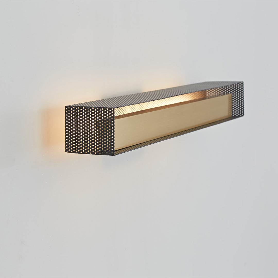 Modern wall picture light with perforated pattern side view, soft wall illumination.