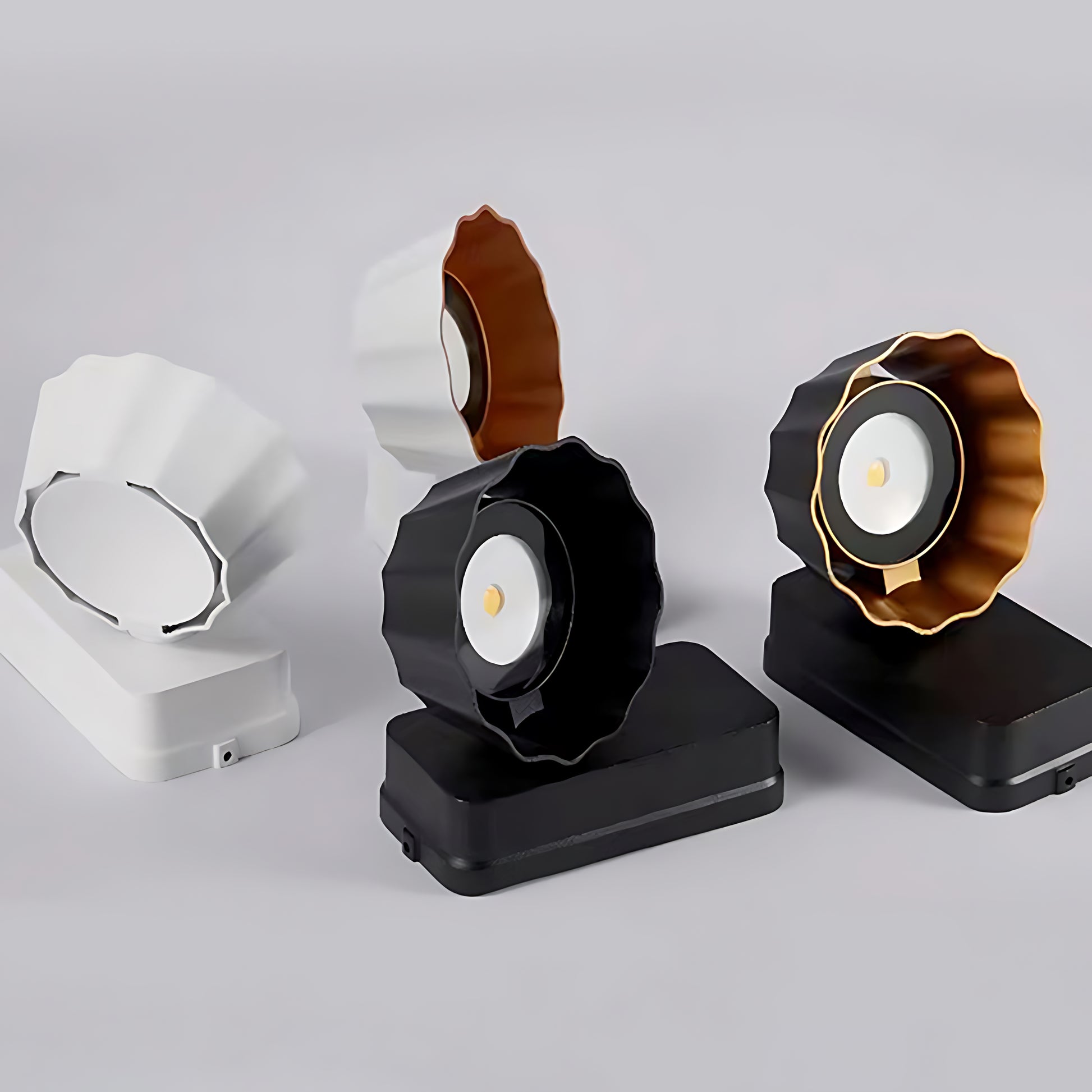 Collection of modern wall sconces in different finishes displayed on white background