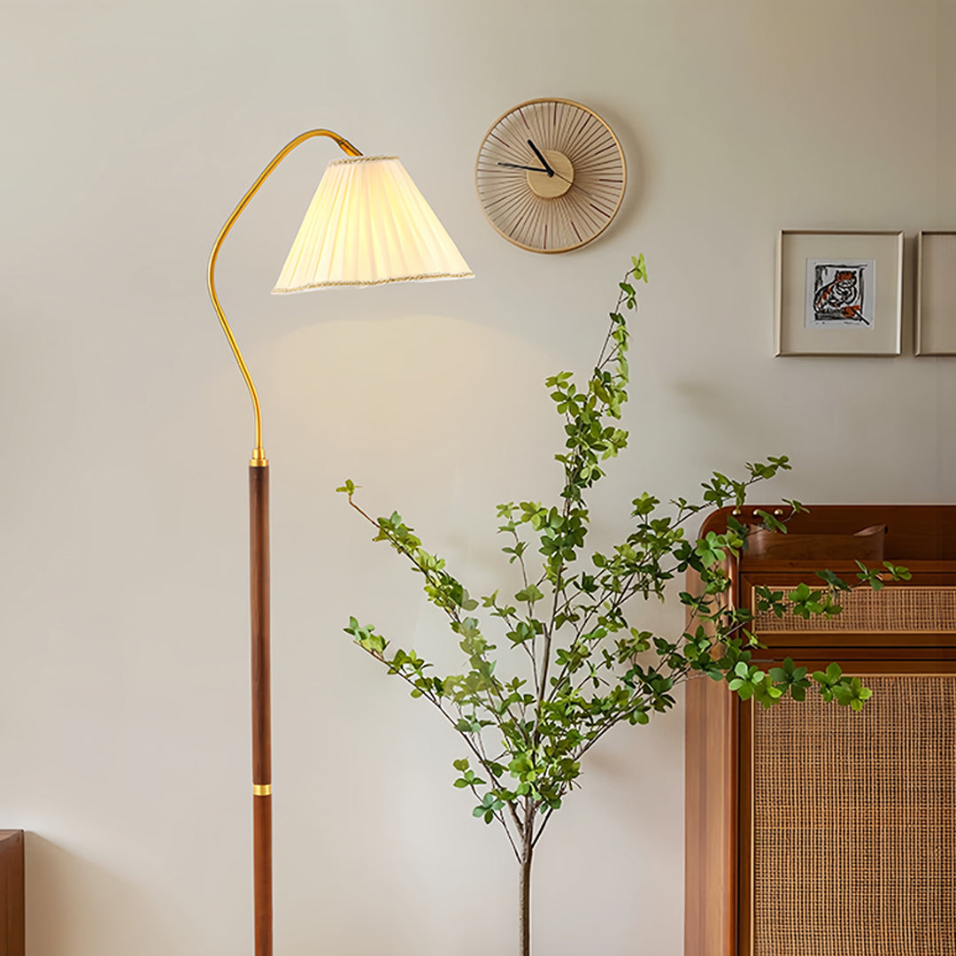Modern walnut floor lamp with brass accents in bright contemporary interior space