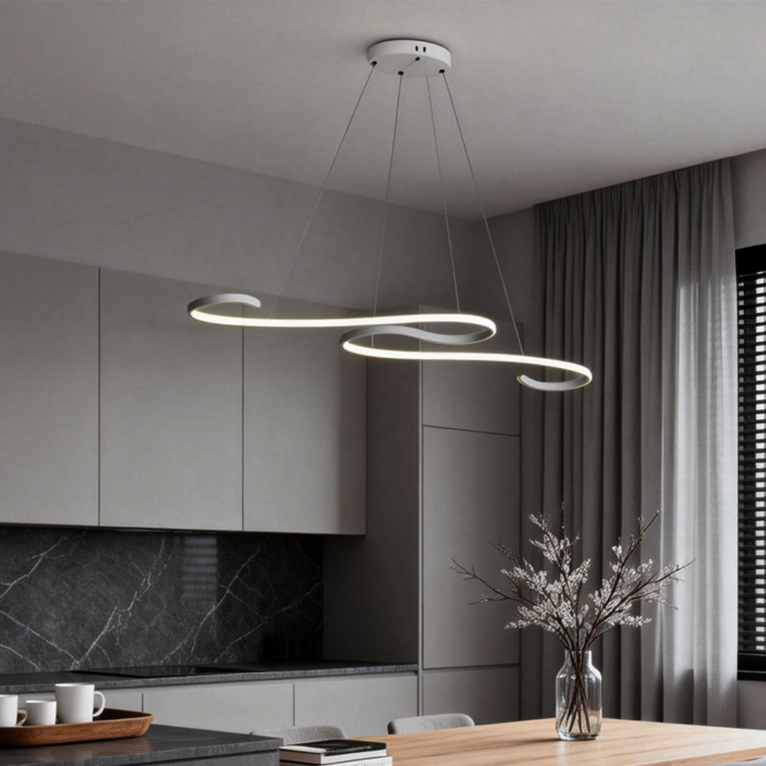 Modern white chandeliers with sleek curved design, hanging above a dining table in a contemporary kitchen.
