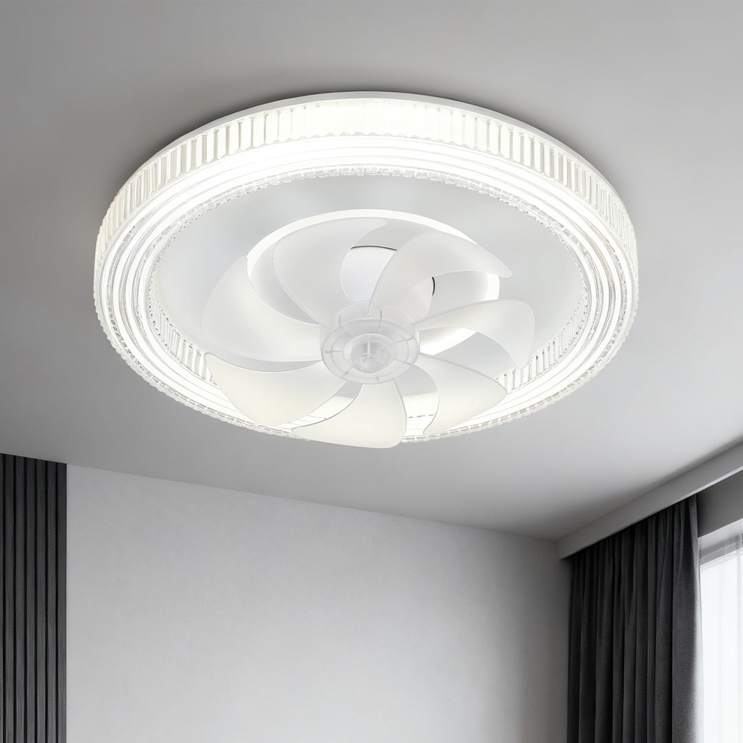 Modern white circular ceiling fan with light fixture installed in a minimalist room with dark curtains and bright white walls. 