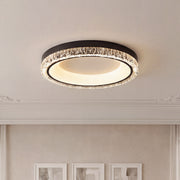 Modern white flush mount ceiling light with a black trim and sparkling crystal textured ring.