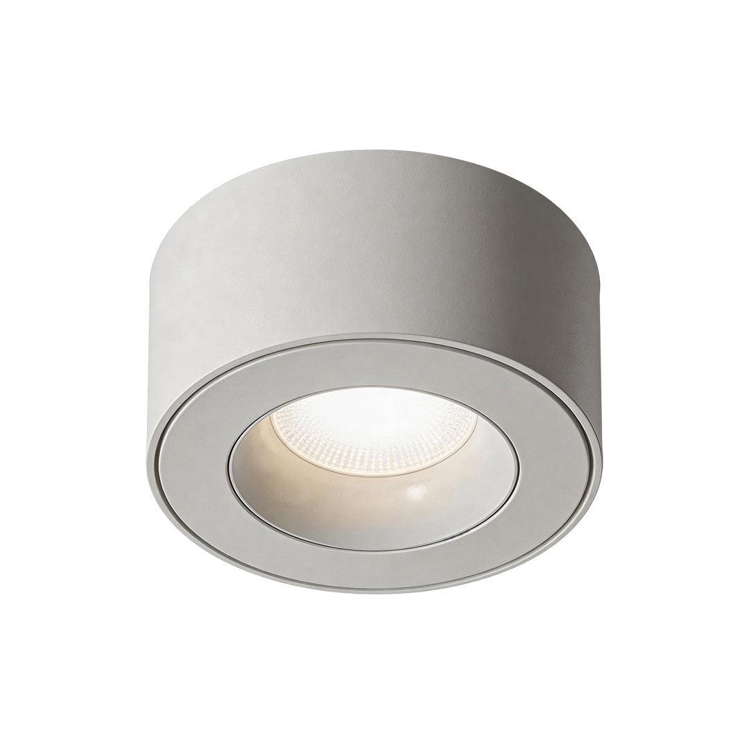 Modern white surface mounted can light offering focused illumination with a minimalist look.