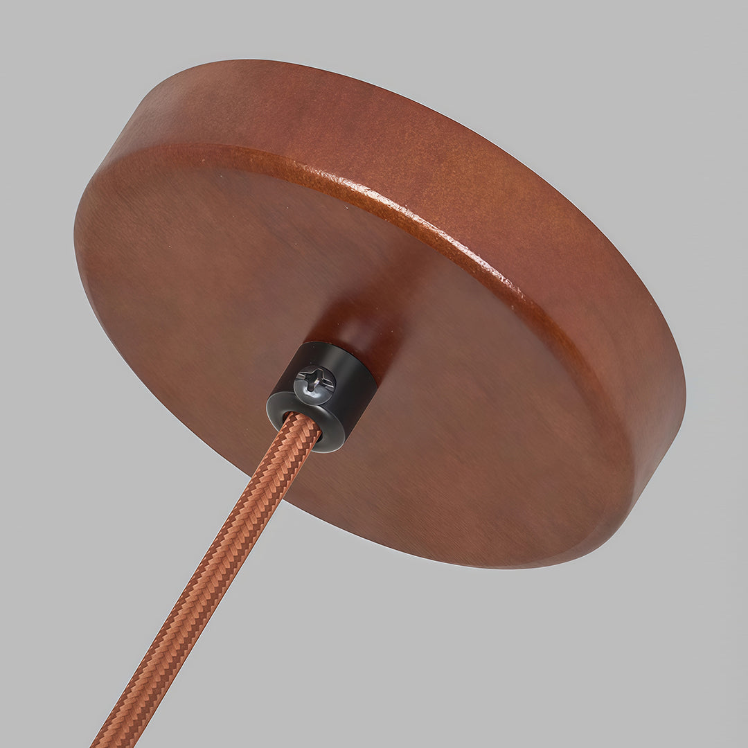 A modern wood pendant light featuring a textured woven shade, providing soft light and adding a rustic charm to a living space.