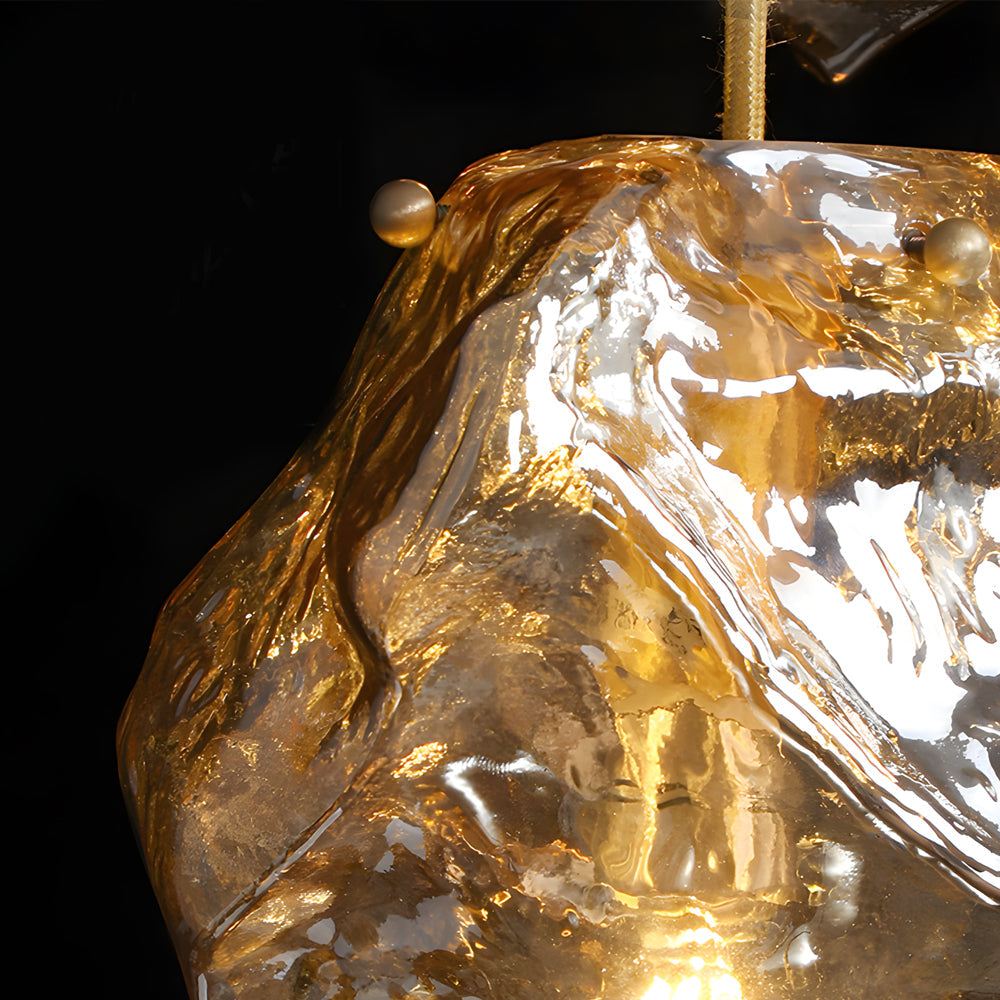 Molten rock pendant light in gold, front view of the artistic design.