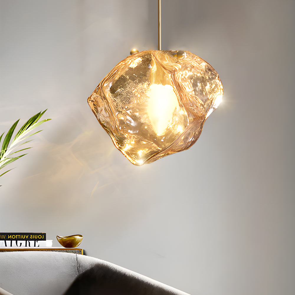Molten rock pendant light enhancing a stylish dining area with unique, organic design.