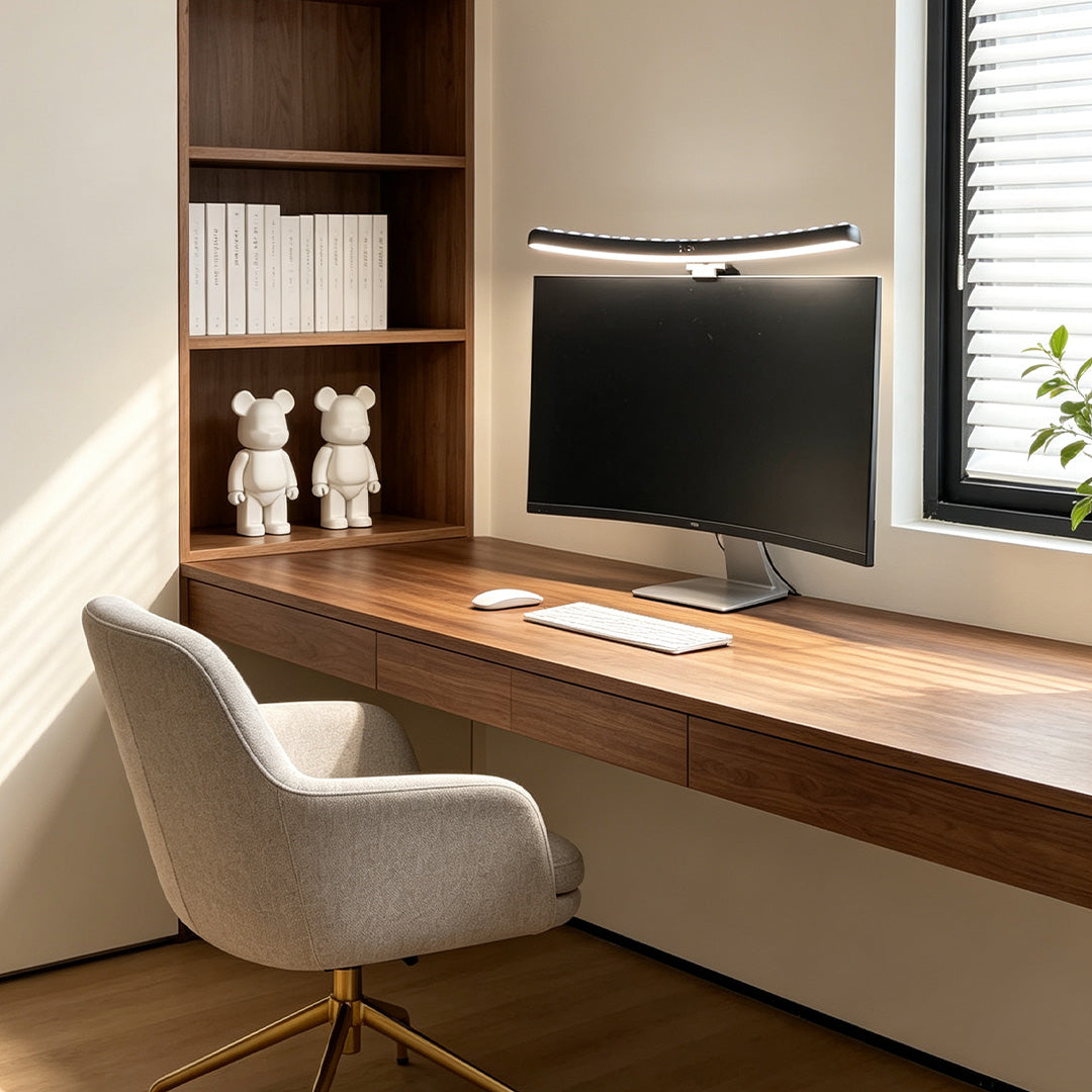 Monitor LED light bar installed above a desktop screen in a built-in wooden home office.