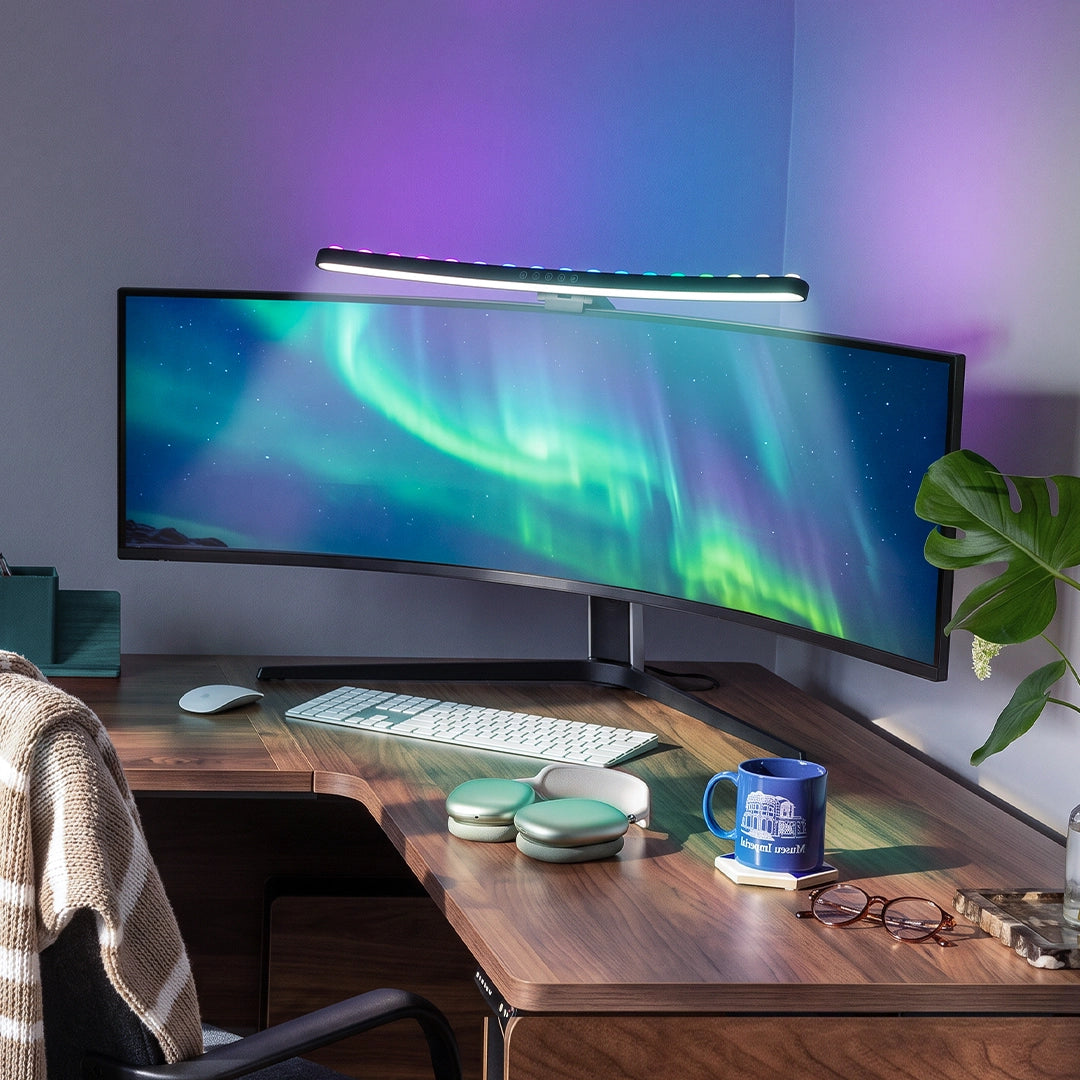 Monitor LED light bar mounted above a curved gaming monitor with colorful ambient wall lighting.