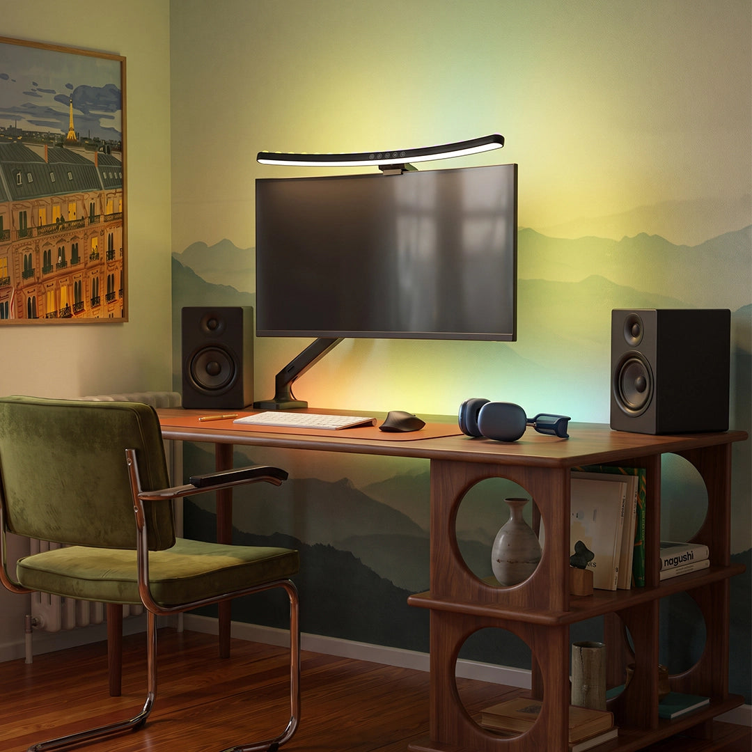 Monitor LED light bar providing focused desk lighting above a computer monitor with speakers and headphones.