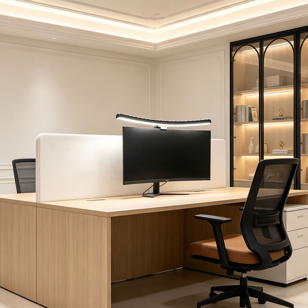 Monitor LED light bar installed above a computer screen in a bright modern office workstation.