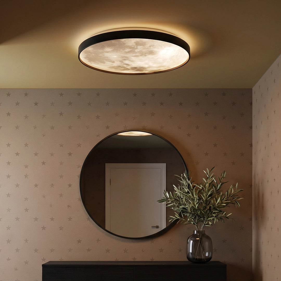 Moon ceiling light mounted in an entryway above a round mirror and decorative vase.