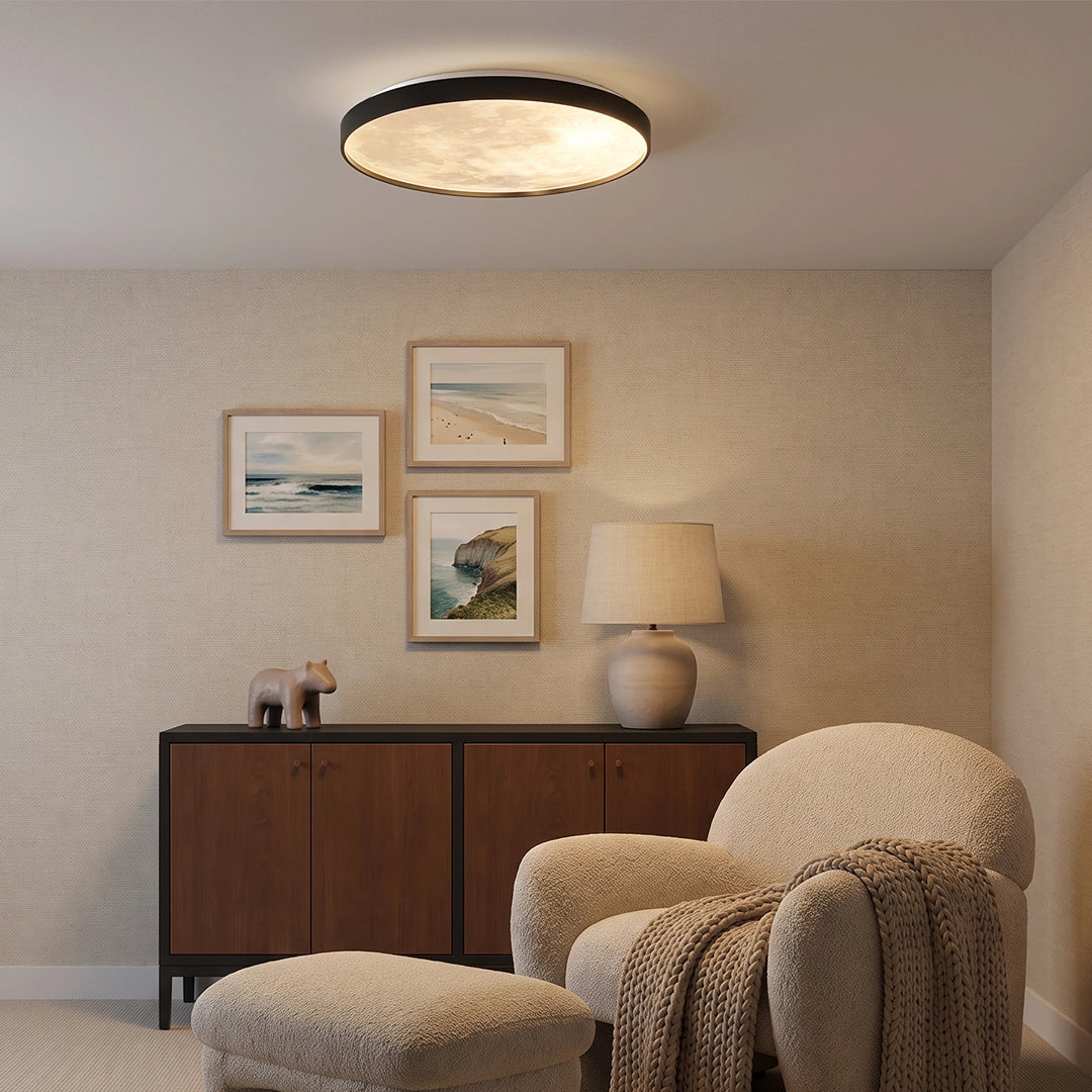 Moon ceiling light installed above a lounge area with a sideboard, armchair, and framed artwork.