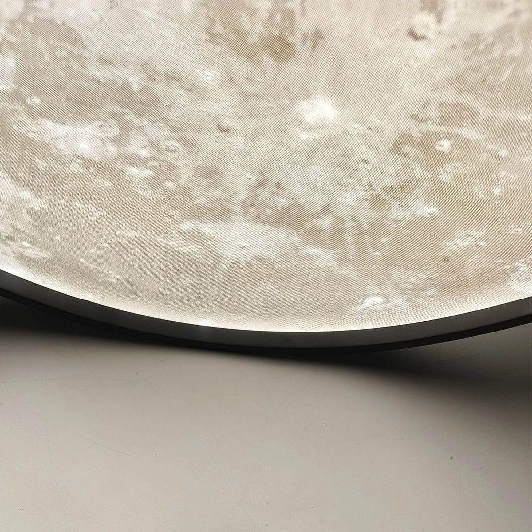 Close-up of the textured illuminated surface of a moon ceiling light.
