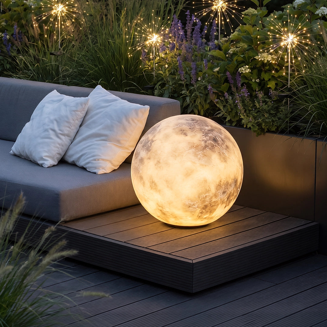 Moon light placed beside a cushioned outdoor sofa, creating a warm ambient glow on the patio.