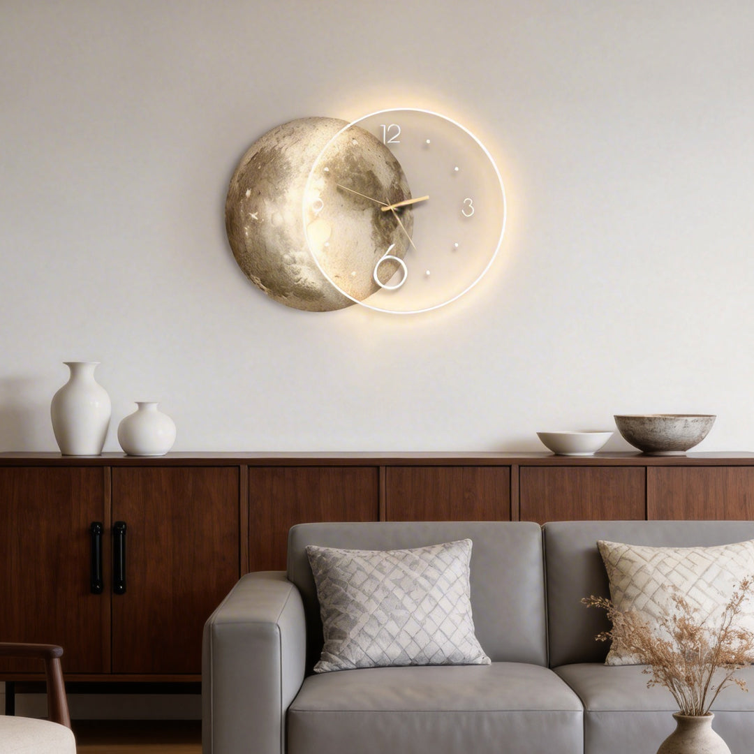 Moon wall clock light with a golden ring design, mounted above a sofa in a modern living room.